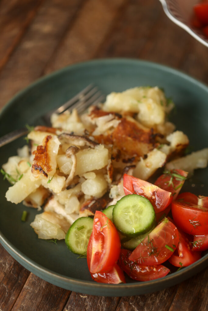 Fries Potatoes with wild mushrooms and onions and with simple cucumber and tomato salad